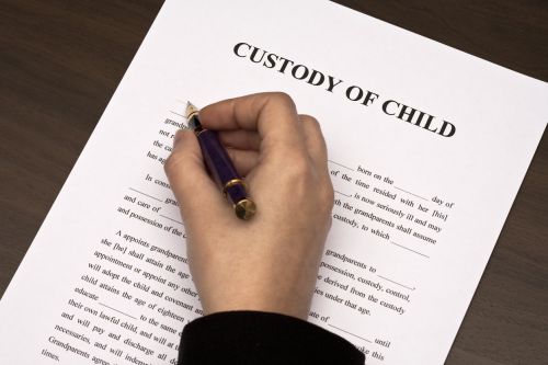 hand filling Custody of Child document